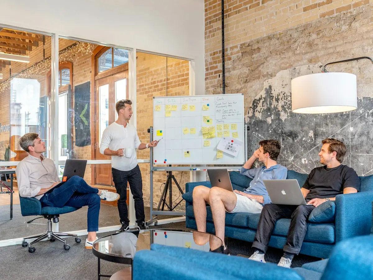 Agency team meeting around a whiteboard